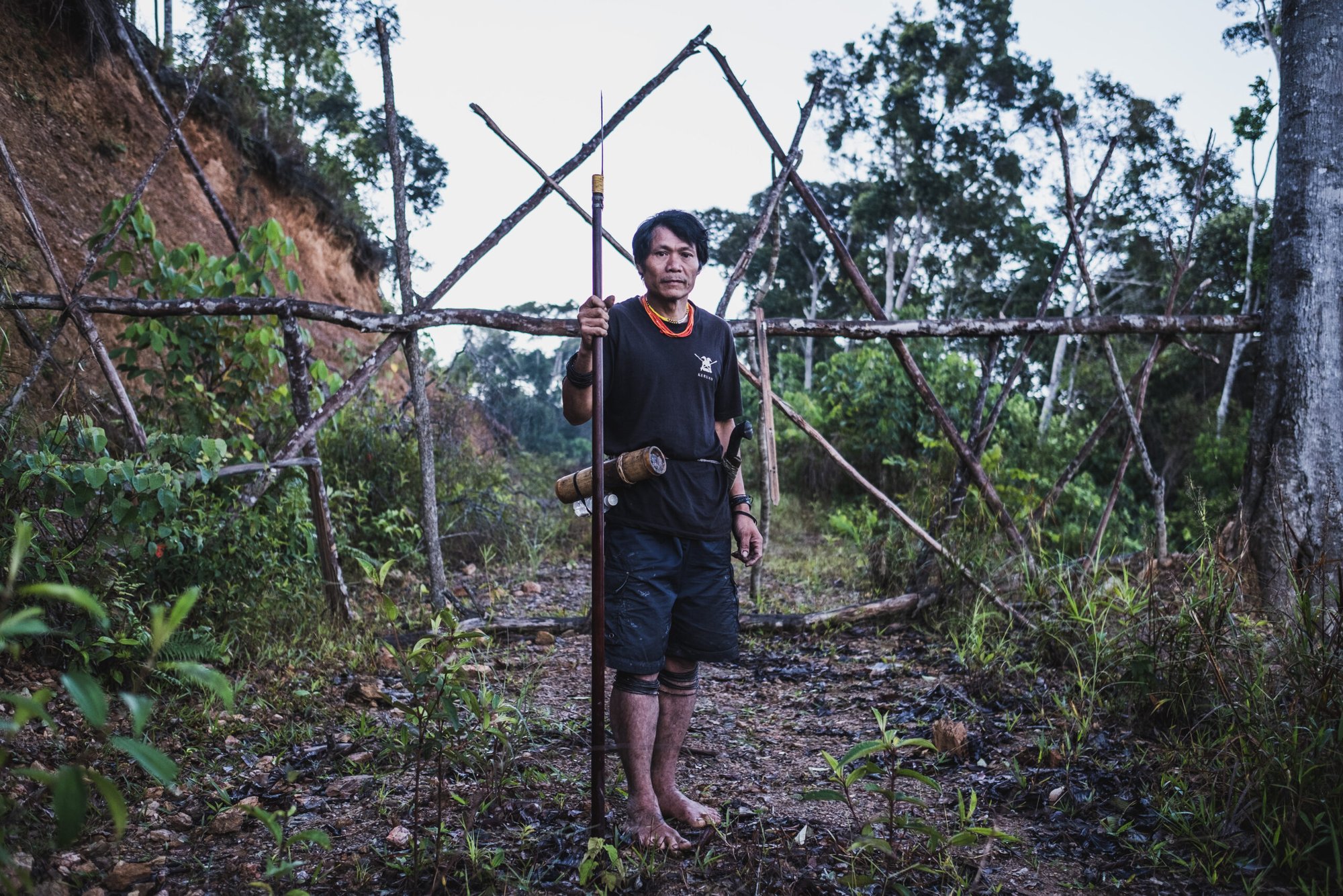Peng Megut, a Penan leader of the Long Tevenga village, is posing in front of a house build as a blockade at a junction toward his village.