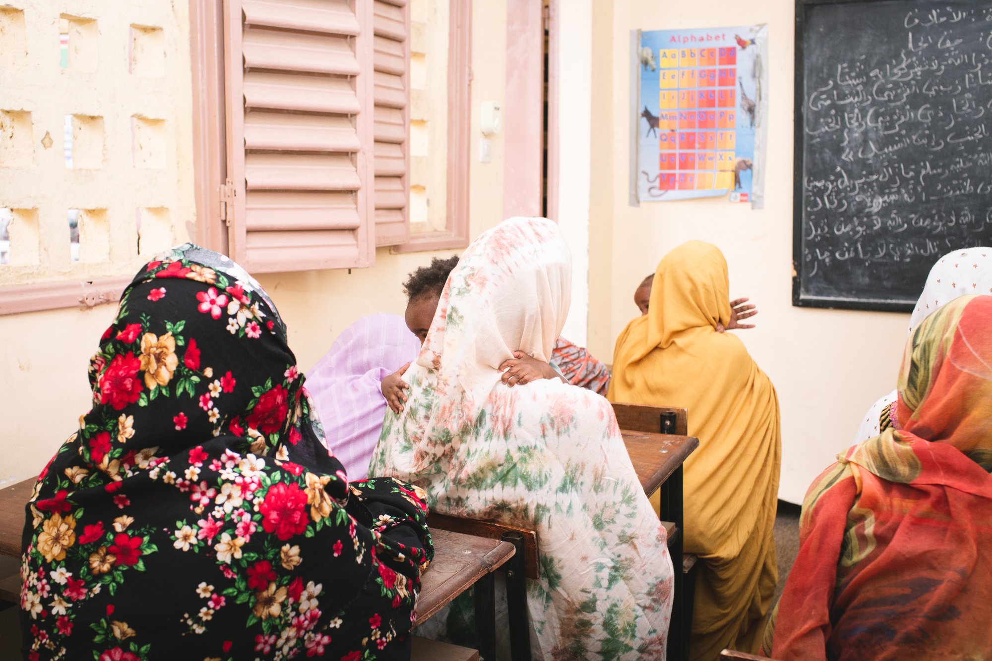 Adolescent girls learn to read and write in Arabic at El Wava, a center in Nouakchott, Mauritania, some holding their children conceived in rape.