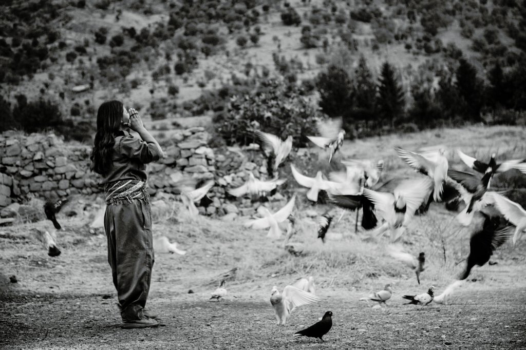 Zilan Tanya, a female PJAK guerrilla in Qandil mountains, binds her hair before commencing her daily routines.