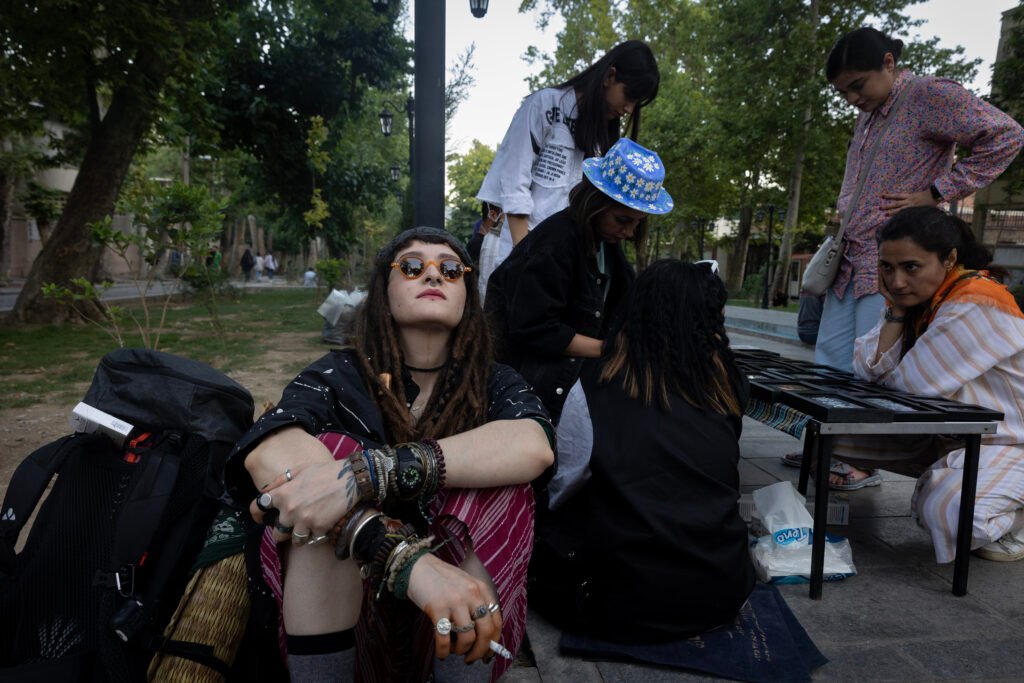 An Iranian girl dresses freely like a hippie as she smokes in the northern part of Tehran.         