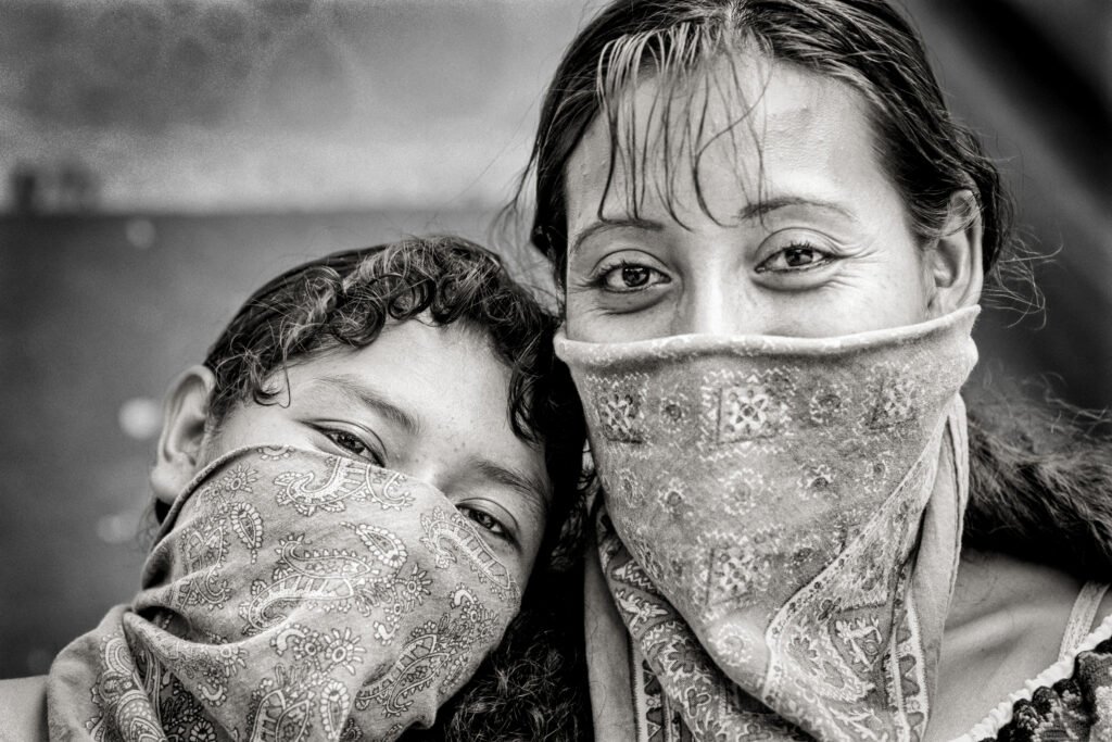 Portrait of two Zapatista women covering their faces with scarves in Lacandon Jungle.