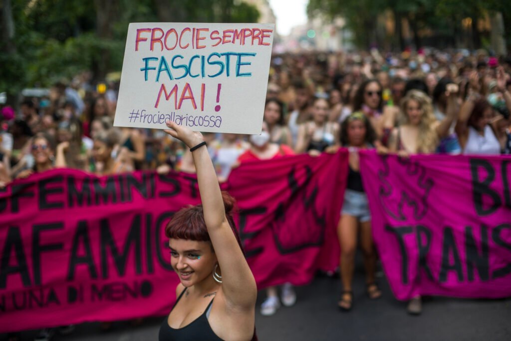 Woman holding a banner "Frocie sempre, fasciste mai!" in feminist protest against fascism, in Bologna, Italy.