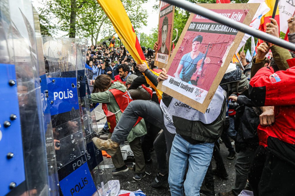 Youth organization "Student Activity" clashes with the police, holding a photo of Kemal Kurkut, in Istanbul, Turkey.