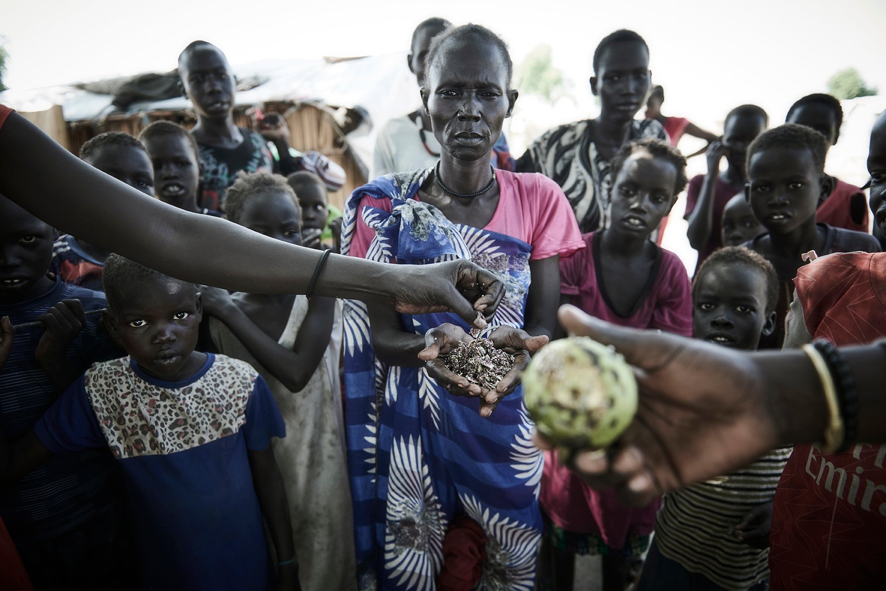 Mary Nyantey and a group of children waiting for Yell river plant to eat as flooding has ravaged traditional livelihood in Bentiu, South Sudan.