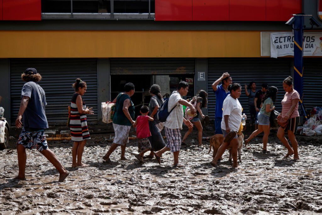 Following the aftermath of Hurricane Otis, individuals could be seen wading through the mud near a vandalized store in the popular tourist destination of Acapulco.