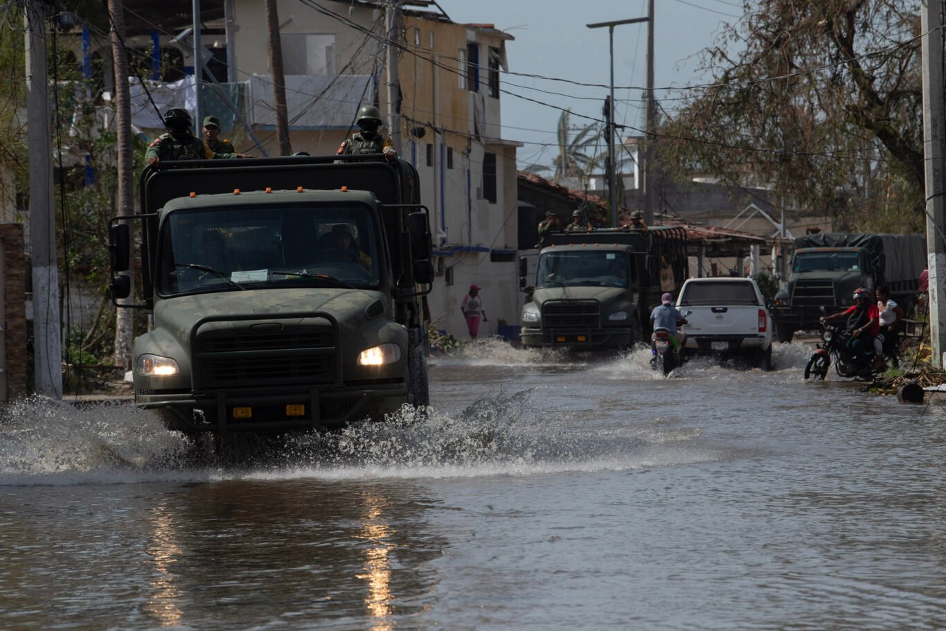 A military convoy driving through the flooded streets of Pie de la Cuesta, in the western part of Acapulco, on October 27, 2023. The Mexican Army and Navy are deployed as part of the DN-III plan in natural disasters or situations where the safety of the population is threatened.