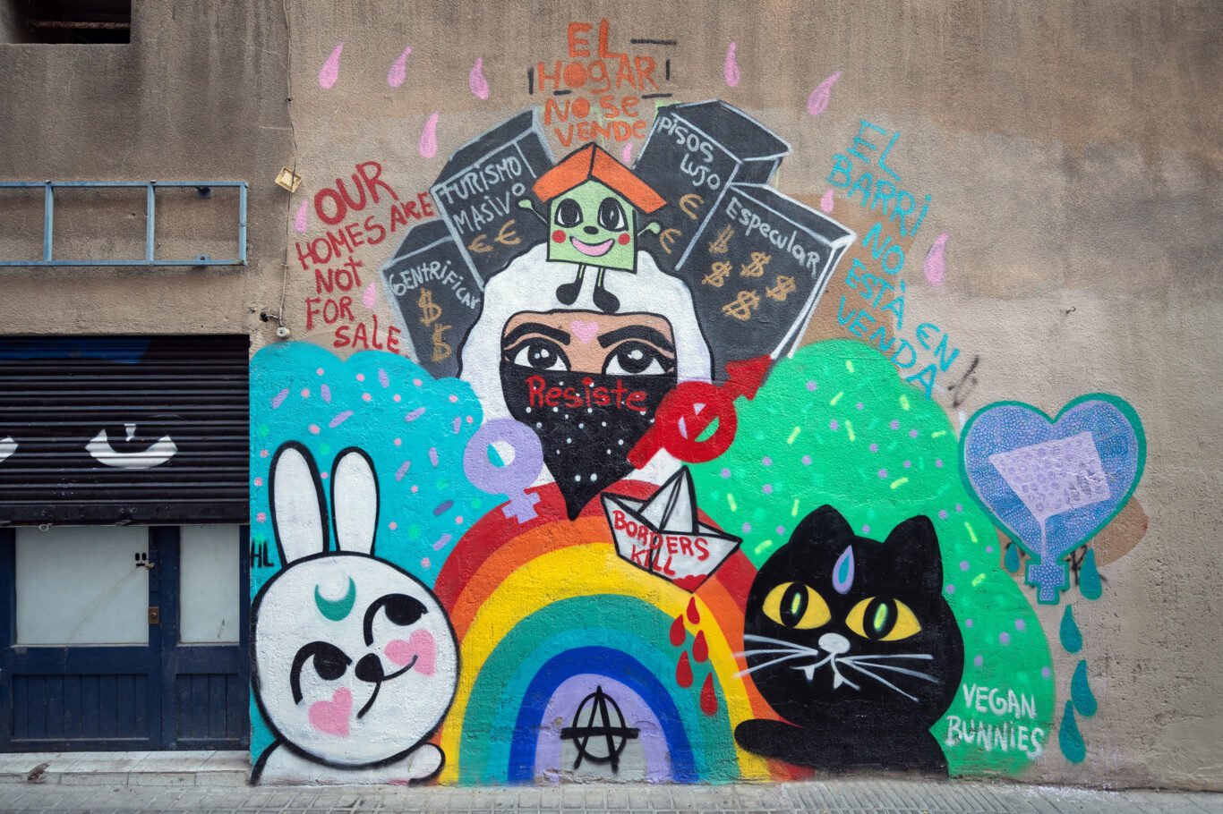 Street art in the Gràcia neighborhood by the Spanish-Peruvian artist Vegan Bunnies confronts gentrification and commercialization of Barcelona.