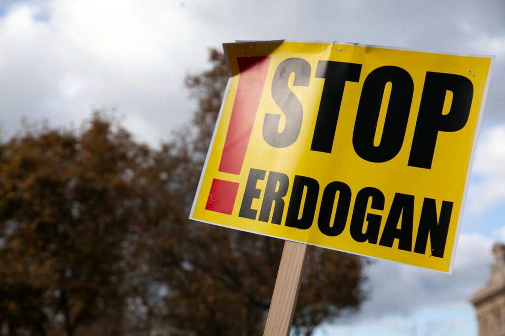 A protester holds a sign reading 'Stop Erdogan' during a peaceful demonstration on World Kobani Day in Paris, France.