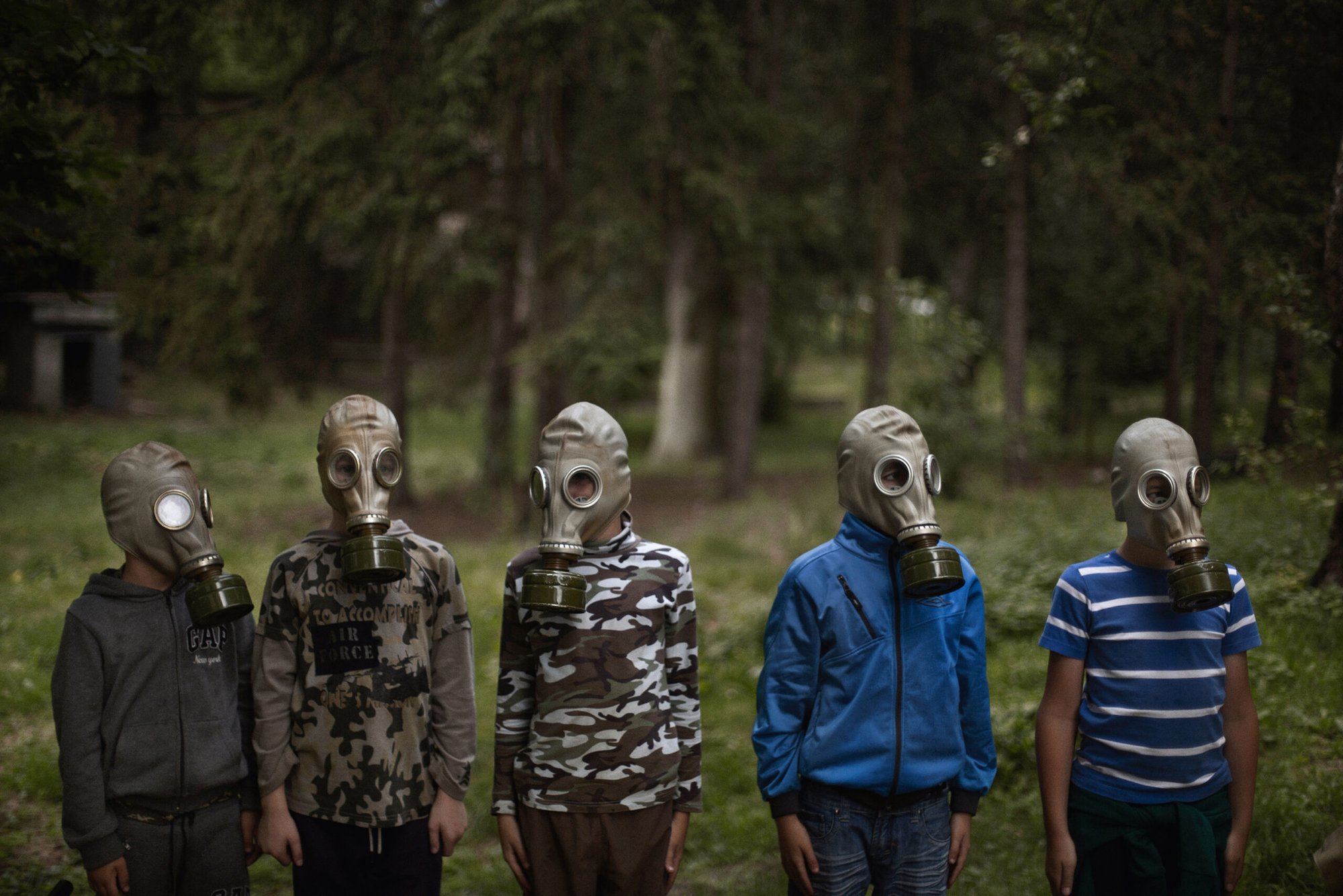 Young Ukrainian boys receive instruction on how to properly don a gas mask at Lider Camp, a hyper-nationalist military summer camp located on the outskirts of Kyiv.