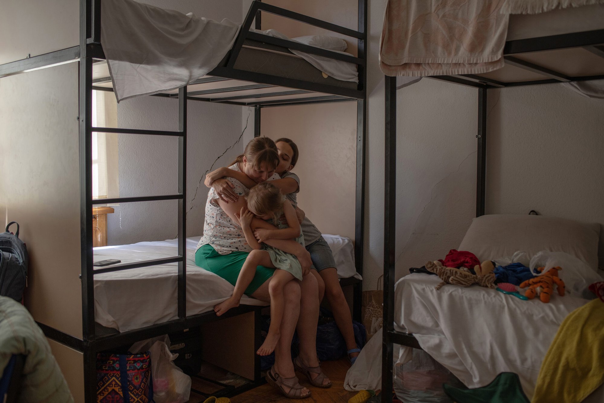 Ukrainian refugee Yulia Morozova with her children in a Geogian dormitory with bunk beds in Tbilisi.