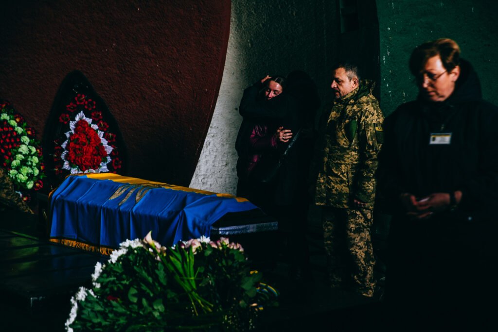 Anastasia, the wife of a soldier Oleh Rybalchenko, who was killed in action in Bakhmut, Donetsk region, mourns at the funeral ceremony in Kyiv.