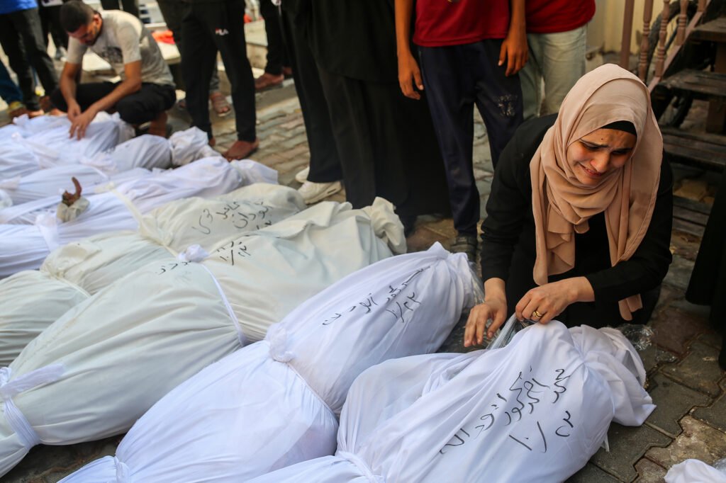 A woman mourns the loss of her brothers and sisters who were killed in Israeli strikes. Deir al Balah, Gaza Strip.