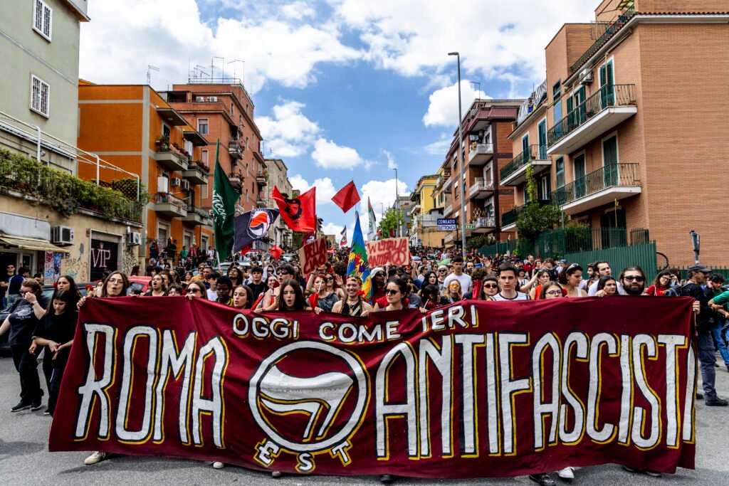 The opening banner of the April 25 march moves down Via dei Gelsi in Centocelle, Rome, as participants commemorate Liberation Day.