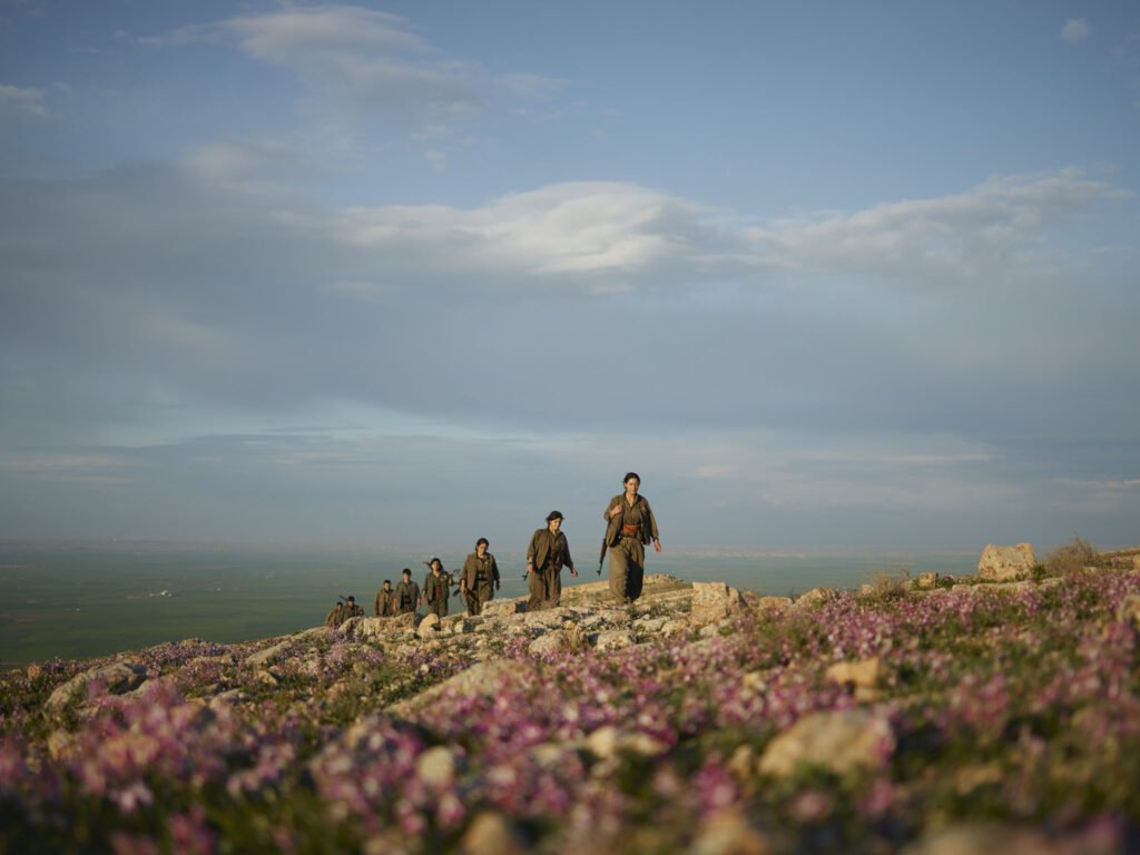 Kurdistan Workers' Party (PKK) guerrillas patrol a flowering hill in Makhmour countryside, Iraq.