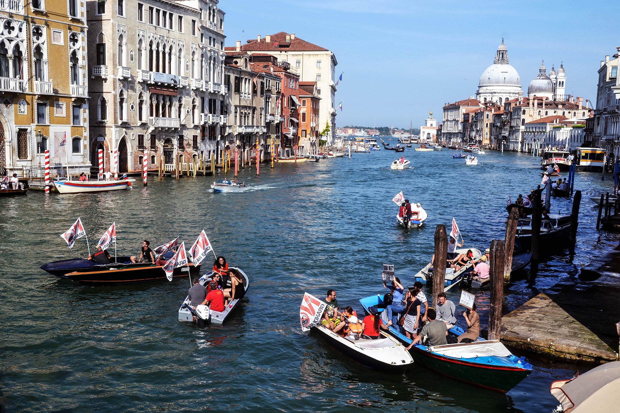 Italy, Venice, June 8, 2019: Protest boats on the Grand Canal demand an end to large cruise ships in Venice.