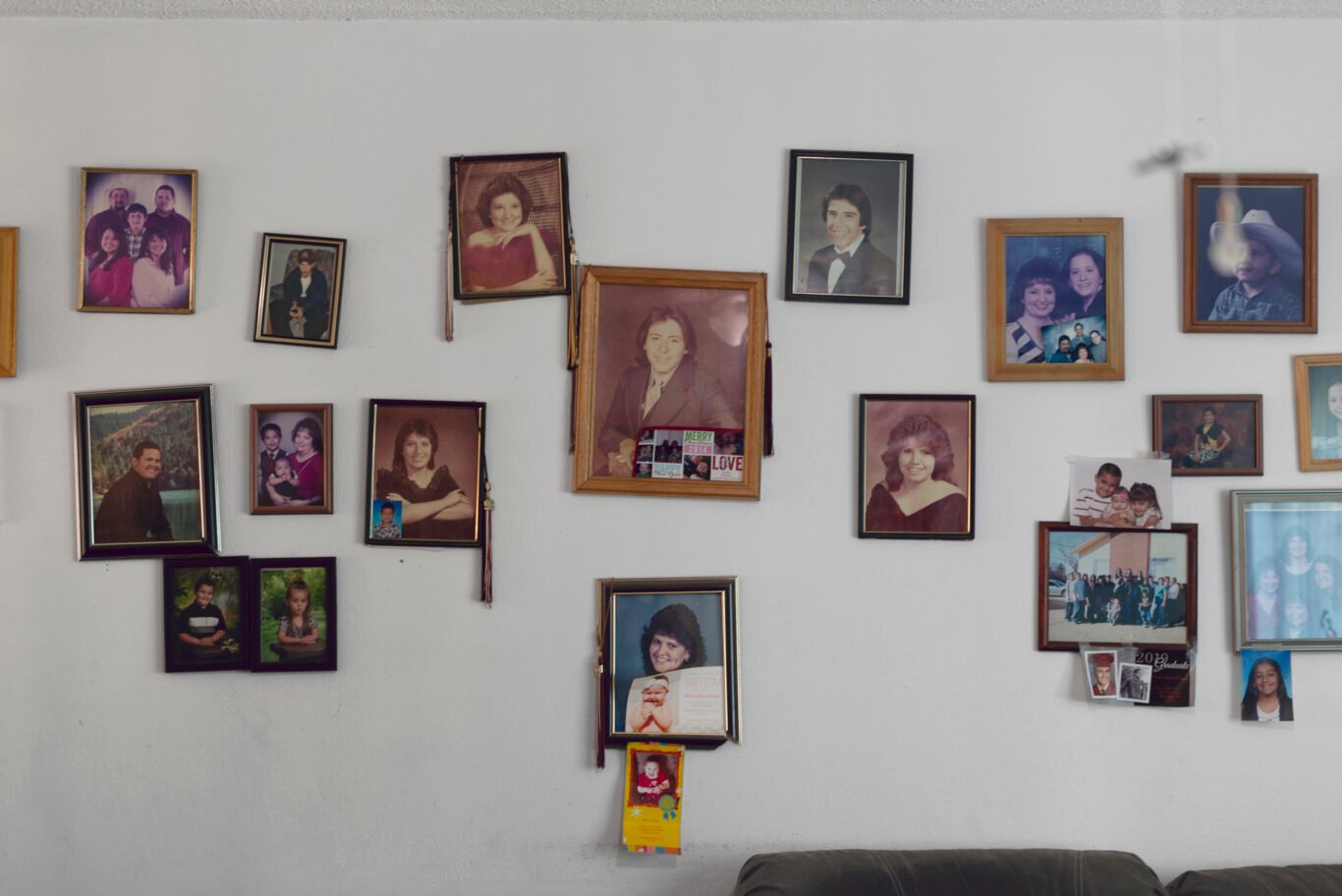Family photographs hang on the wall in Andrea Carrillo's mother's home on Sierra Blanca Rd in Tularosa, NM.