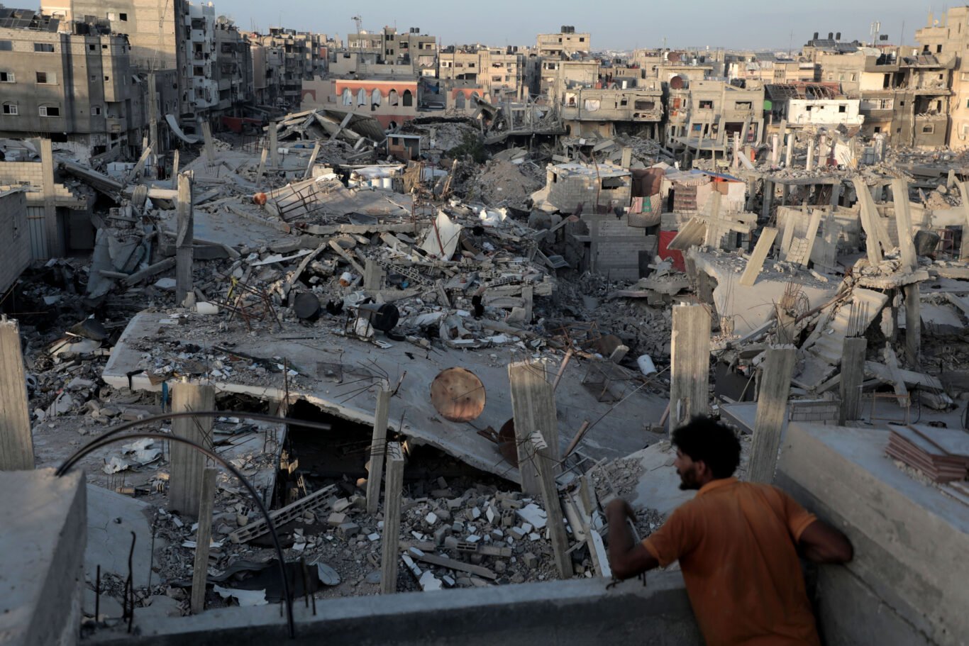 A Palestinian looks out from the window of his destroyed home in the Jabalia refugee camp, northern Gaza Strip, after the Israeli army’s partial withdrawal left the city in ruins.