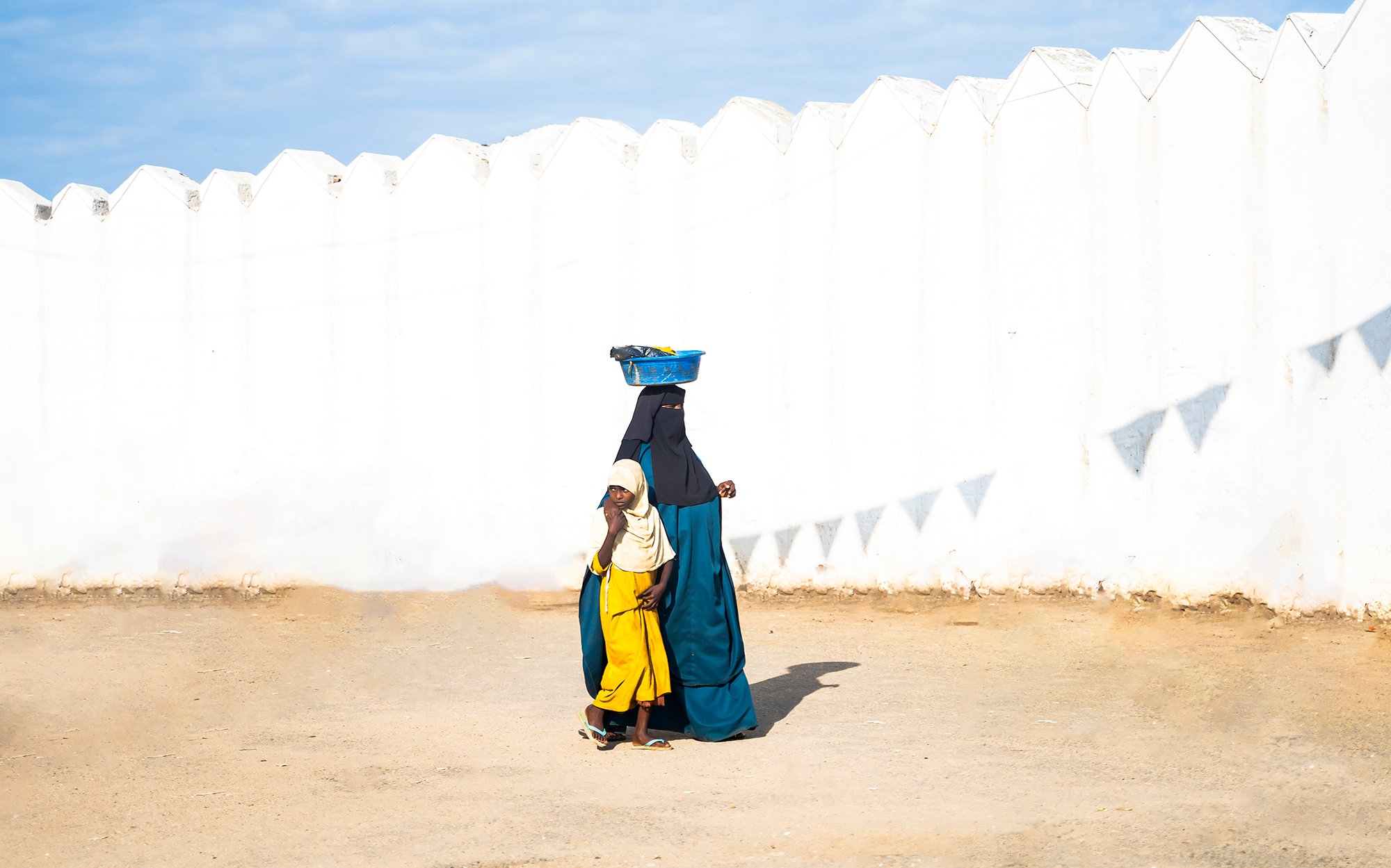 A mother and daughter returning home from market in Harar, Ethiopia.