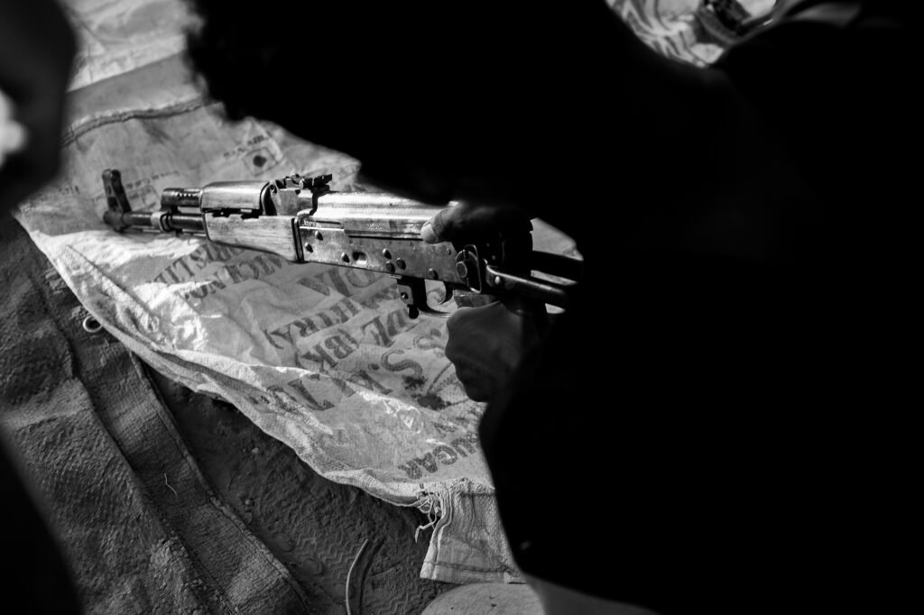 A SAF recruit checks his rifle at a training post in Omdurman.
