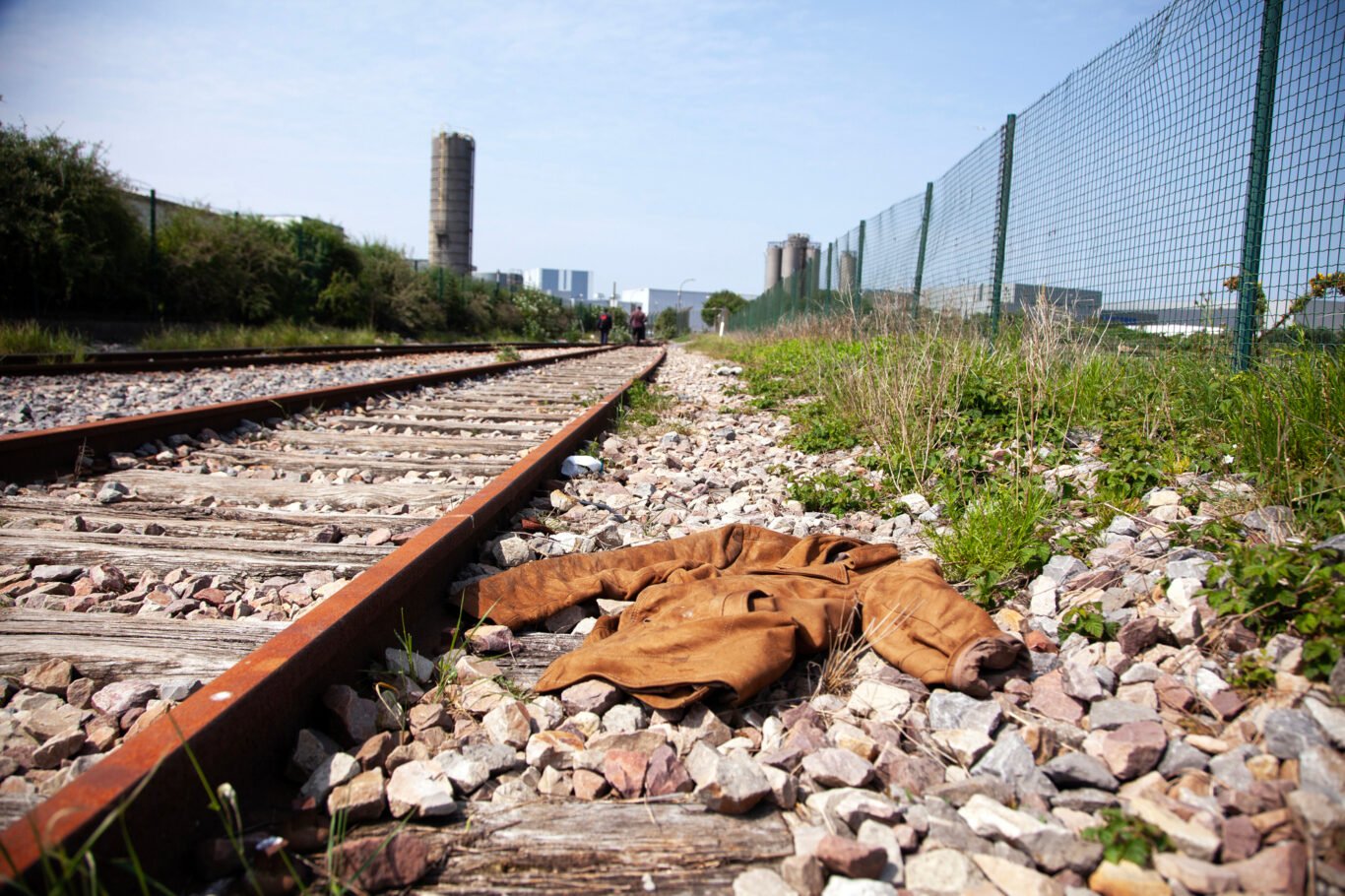 Beside the tracks, a coat remains, a silent witness to those who passed through Calais seeking safety. May 2014.